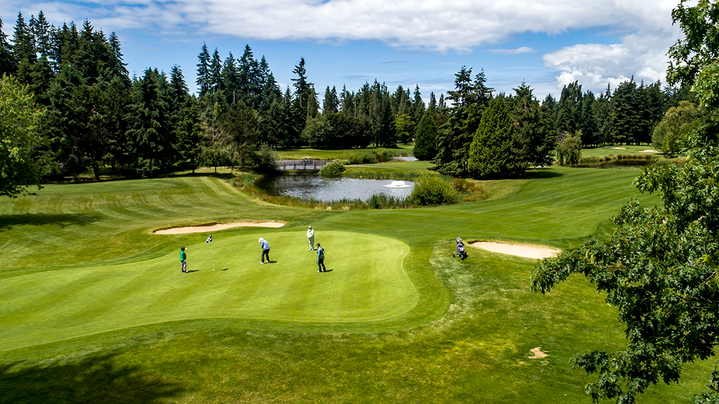 Golf course green with players on course